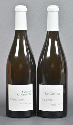 two bottles of wine sitting next to each other on a table