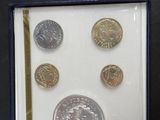 a picture of a picture of some coins in a box