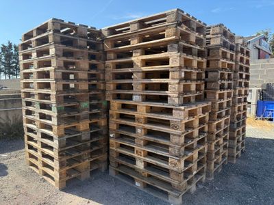 several wooden pallets stacked on top of each other in a yard