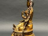 an image of a statue of a woman sitting on a chair