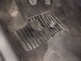 a dirty floor with a car ' s floor drain in it