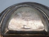 a close up of a silver plate on a table