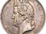 gros plan d'une pièce de monnaie sur laquelle figure une tête d'homme
