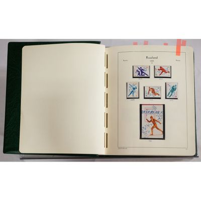 an open book with stamps on it on a table