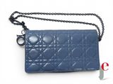 a close up of a blue purse with a chain around it