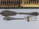 a lot of forks and spoons that are sitting on a table