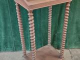 an old wooden table with a drawer on top of it