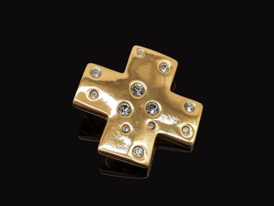 une image représentant une croix en or sertie de diamants sur fond noir