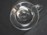 a glass cup that is sitting on a black table