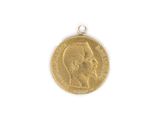 a close up of a gold coin with a man ' s face on it