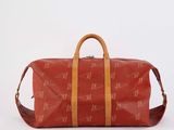 an image of a red duffel bag sitting on top of a white surface
