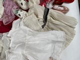 a lot of clothes and shoes on a bed