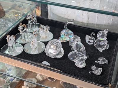 a glass display case with glass figurines in it