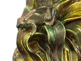 a statue of a man with a beard and a bird on it ' s head