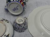 three plates and a teapot on a table