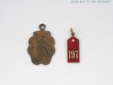two small metal tags with a picture of a woman on them