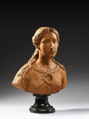 a carved bust of a woman on a pedestal