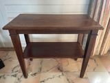 a wooden table with a shelf on top of it