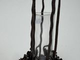 a glass vase with sticks sticking out of it on a table