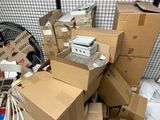 a pile of cardboard boxes and other items in a room