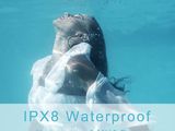 a woman in a white dress swimming under water