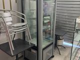 an image of a refrigerator and a chair in a room