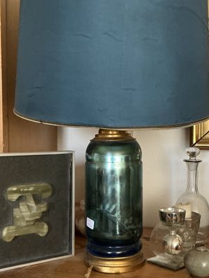 une lampe posée sur une table à côté d'un tableau