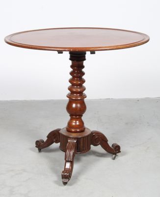 a wooden table with a round top and a wooden base