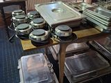 many trays and pans on a table in a kitchen