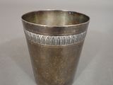 a silver cup that is sitting on a table
