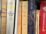 many books that are on a shelf in a room