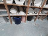 many plates and bowls on the shelves in the room