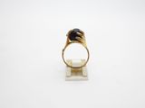 an image of a gold ring with a black stone on it