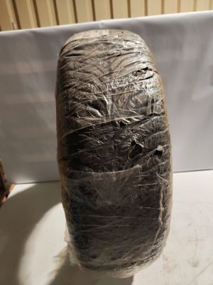 a piece of plastic wrapped around a vase on a table