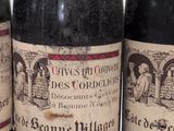 three bottles of wine sitting on top of a white table