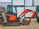 a small excavator that is sitting in the dirt