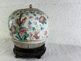 an image of a white vase with a bird and flowers on it