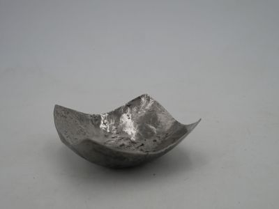 a silver bowl that is sitting on a table