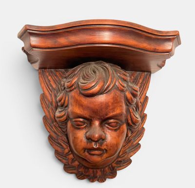 an image of a carved head on a shelf above a shelf