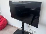 a flat screen tv sitting on a stand in the corner of a room
