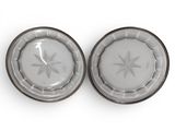 two plates with a star design on them on a white surface