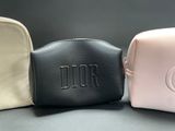 a close up of three different colored bags on a table