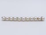 a close up of a white pearl beaded necklace on a white background