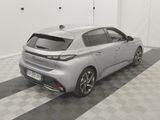 the rear end of a silver car parked on a checkered floor