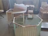 two baby cribs in the middle of a room