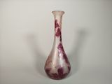 a glass vase with a red and white design on it