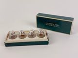 three salt and pepper shakers in a box on a table