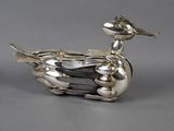 an image of a silver duck figurine sitting on top of a table