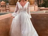a woman in a wedding dress standing on a balcony