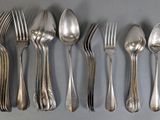 five silver spoons and six silver spoons on a table